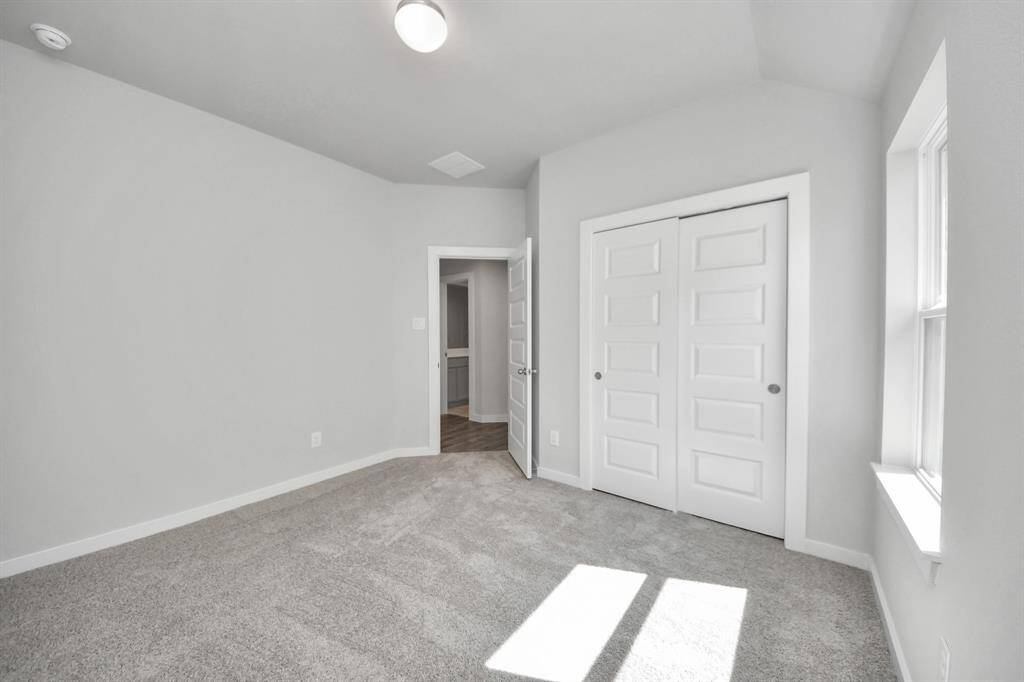 Generously sized secondary bedrooms featuring spacious closets, soft and inviting carpeting underfoot, large windows allowing plenty of natural light, and the added touch of privacy blinds for your personal retreat.