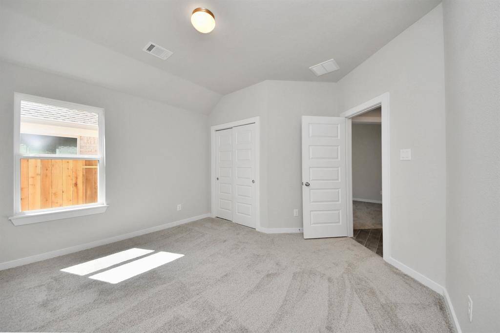 Generously sized secondary bedrooms featuring spacious closets, soft and inviting carpeting underfoot, large windows allowing plenty of natural light, and the added touch of privacy blinds for your personal retreat.