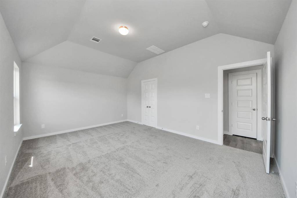 Escape to tranquility in this spacious primary room, adorned with plush carpeting and bathed in the soothing hues of warm paint colors, creating a cozy retreat for relaxation.