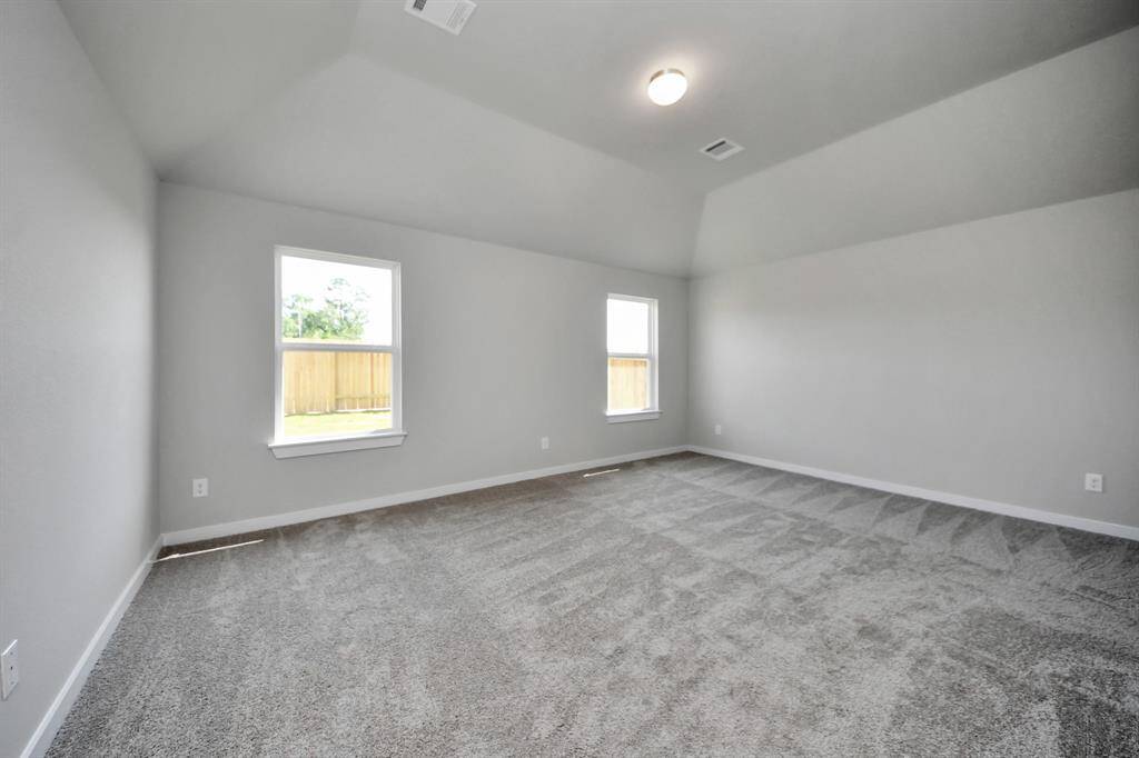 Another perspective unveils a comprehensive view of the serenity and comfort this primary suite offers