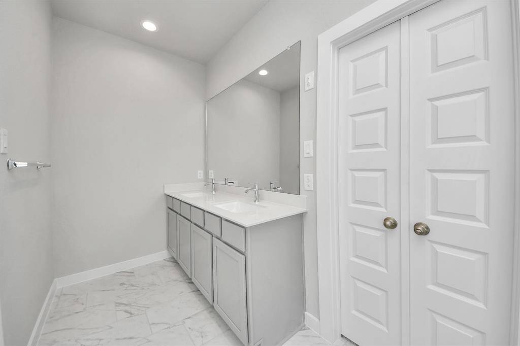 Experience a spa-like escape right in the heart of your primary bathroom. The expansive walk-in shower, surrounded by tile, and the distinctive garden tub with unique accents elevate your daily routine.