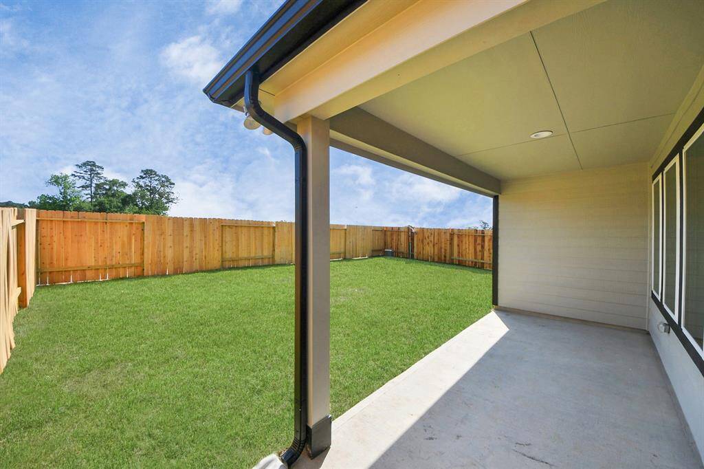 Experience outdoor living at its finest on this expansive covered patio, thoughtfully designed for BBQs and delightful outdoor dining