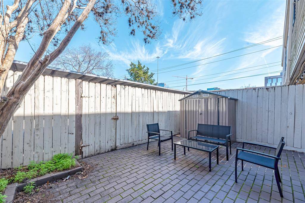 A private, spacious back patio with a cozy seating area, perfect for outdoor relaxation.