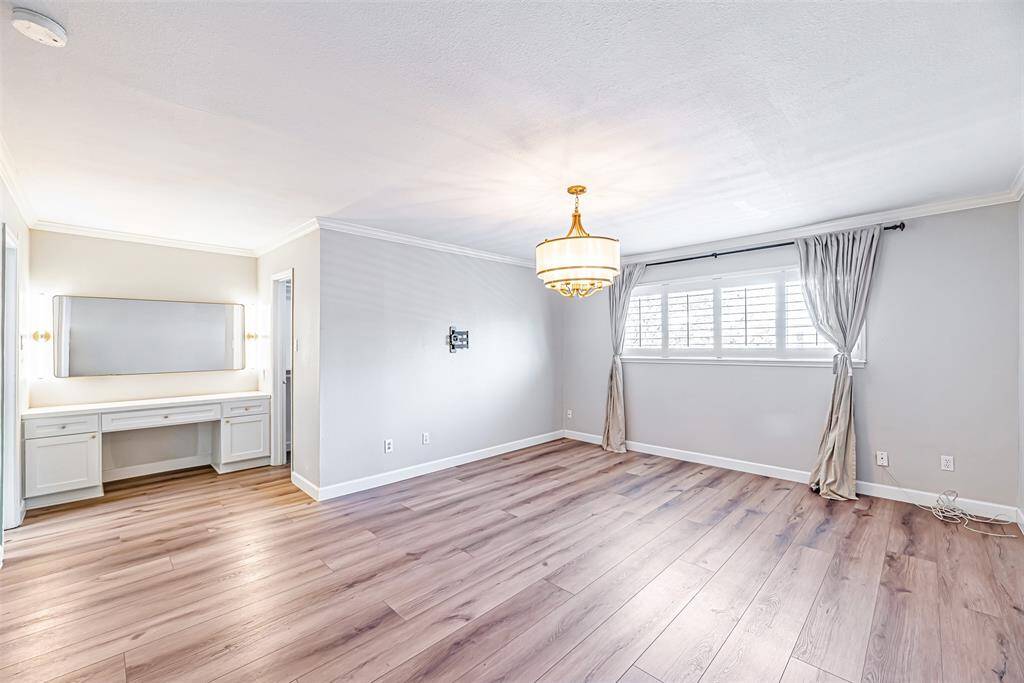 A serene master suite featuring a spacious layout, large windows, and a calming atmosphere.