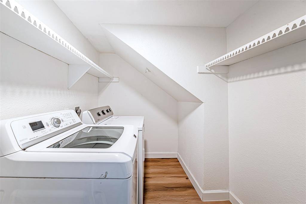 Dedicated laundry space with washer/dryer and ample storage.
