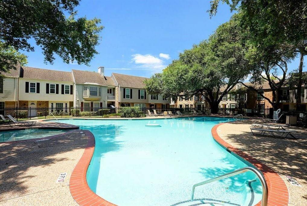 A view highlighting the pool's size and surrounding greenery.