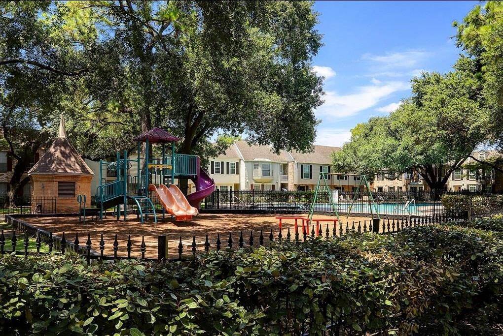 A well-maintained playground area with swings and slides for kids to enjoy.