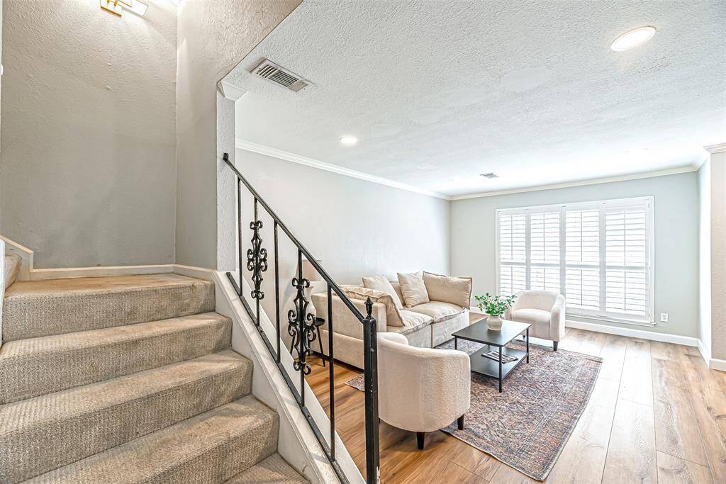 A second view of the living room highlighting its spacious layout and decor potential.