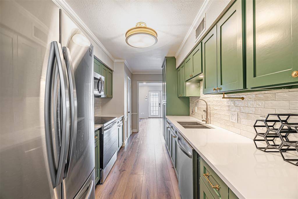 Updated kitchen with modern appliances, generous counter space, and sleek cabinetry.