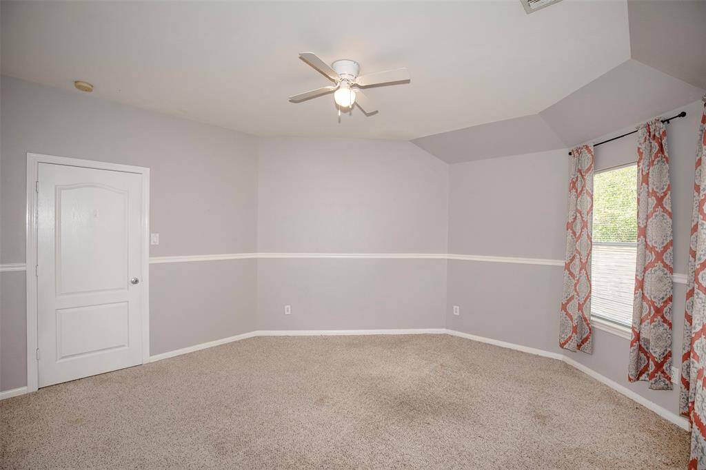 large secondary bedroom with vanity area and walk-in closet