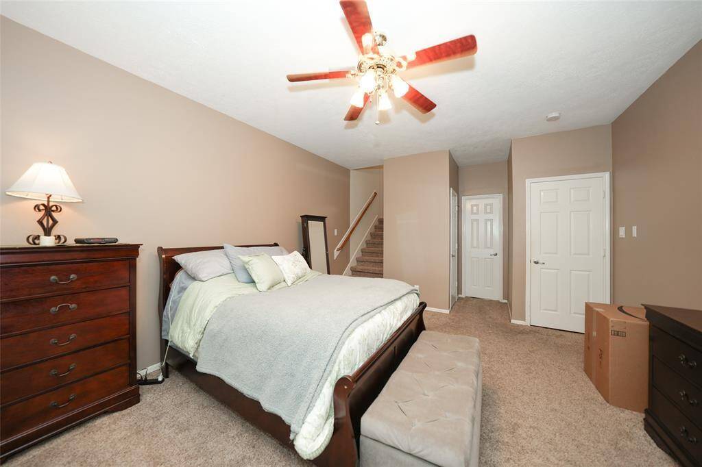 Another view of primary bedroom- stairs to private loft