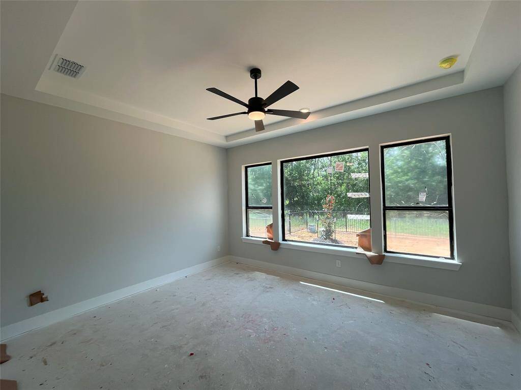 Primary bedroom with oversized window overlooking your greenbelt lot.