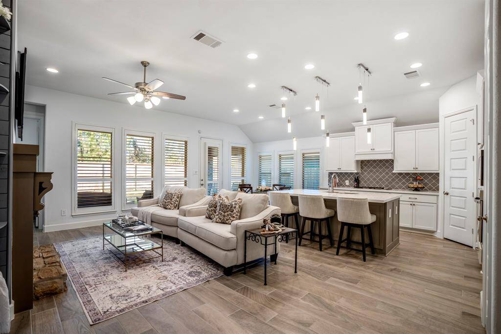 This will be the heart of the home! This image features a beautifully designed open-concept living space that integrates a kitchen, dining area, and living room. The layout is open and spacious, making it perfect for family gatherings or entertaining guests.