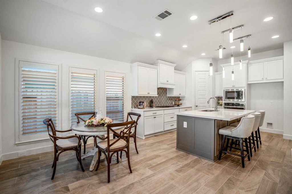 Large windows with plantation shutters allow for natural light while maintaining privacy. You also enjoy the view into the backyard which is a beautiful site as you wind down from the day.