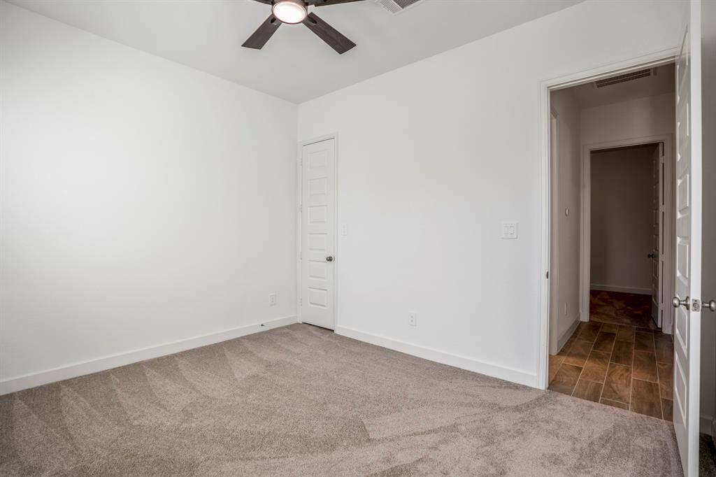 A standard door leads to a closet, offering ample storage space for clothing or other items.
