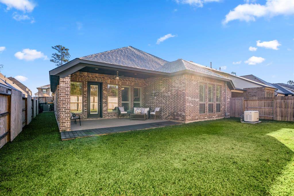 This is a spacious and inviting backyard, ideal for outdoor relaxation and entertainment. A brick-covered patio with ample space for outdoor seating, protected from the elements.Features a ceiling fan for added comfort during warmer weather. The home’s brick exterior adds a classic and cohesive look to the backyard design.