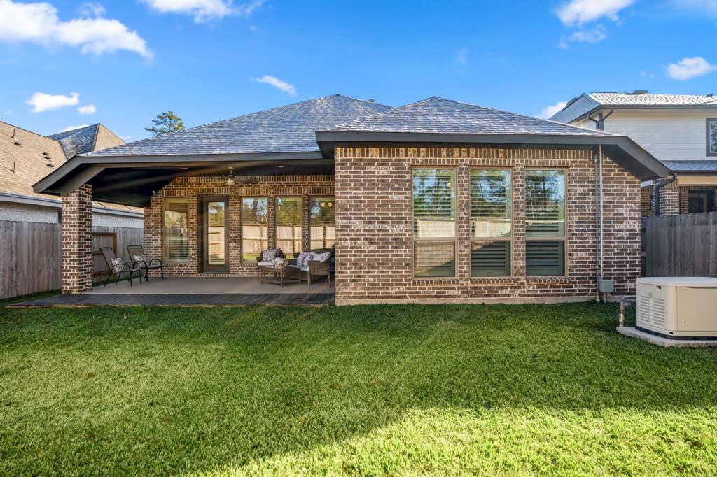 This is a spacious and inviting backyard, ideal for outdoor relaxation and entertainment. A brick-covered patio with ample space for outdoor seating, protected from the elements.Features a ceiling fan for added comfort during warmer weather. The home’s brick exterior adds a classic and cohesive look to the backyard design.