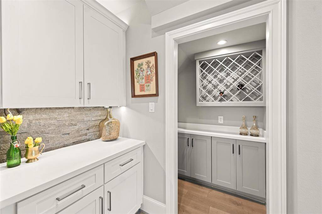 A drybar is near the dining room, and adjacent to that is a cozy alcove for wine storage.