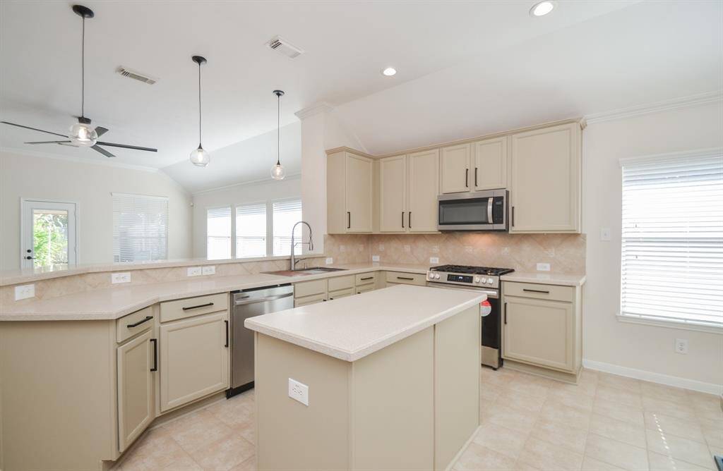 Wide traveling floor space, counters and cabinetry are everywhere you need them to be, plus the benefit of a beautiful island, always welcoming casual stools for quick snacking.