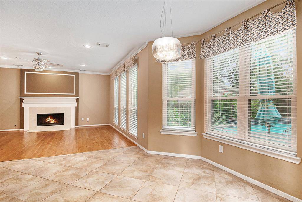 The open family room is designed to be a favorite gathering spot for family and friends. Its spacious layout invites connection, while the centrally located fireplace adds warmth and charm, making it the perfect place to cozy up on those chilly Texas nights