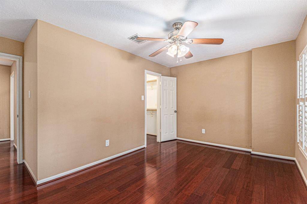 The family room features gorgeous wood floors and a striking wall of windows that flood the space with natural light while offering stunning views of the backyard paradise—blurring the lines between indoor and outdoor living.