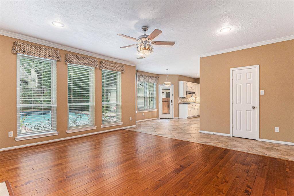 Tucked behind elegant French doors, the study is a private retreat featuring rich wood floors and stunning wood paneling, creating a warm and sophisticated ambiance—perfect for work or relaxation.