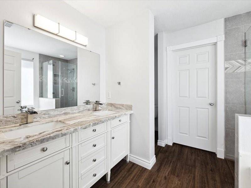 Gorgeous primary suite with upgraded granite, light fixture and recent cabinetry.