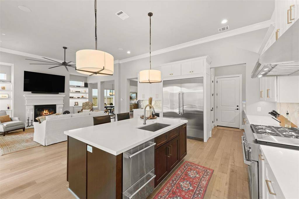 The island features a stainless steel sink and touchless Delta® faucet.