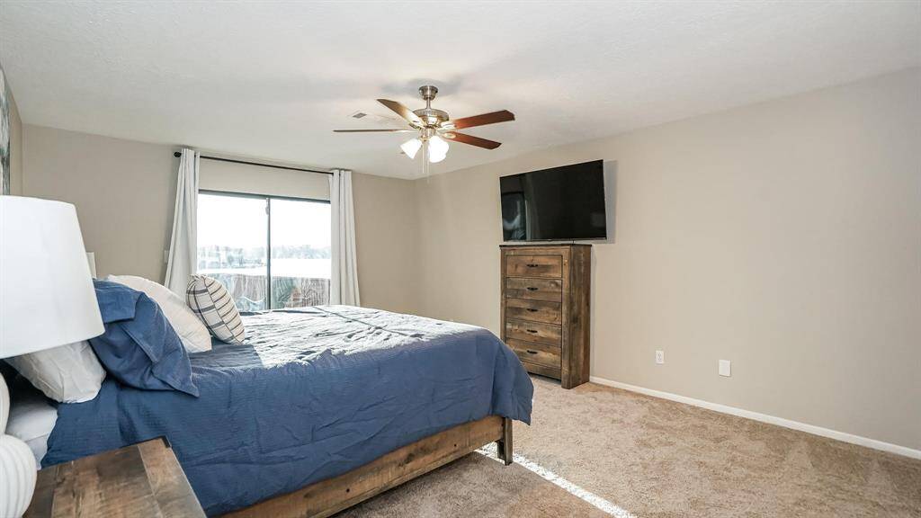 The third bedroom also has carpet floors, a ceiling fan and sliding glass doors to access the patio area.