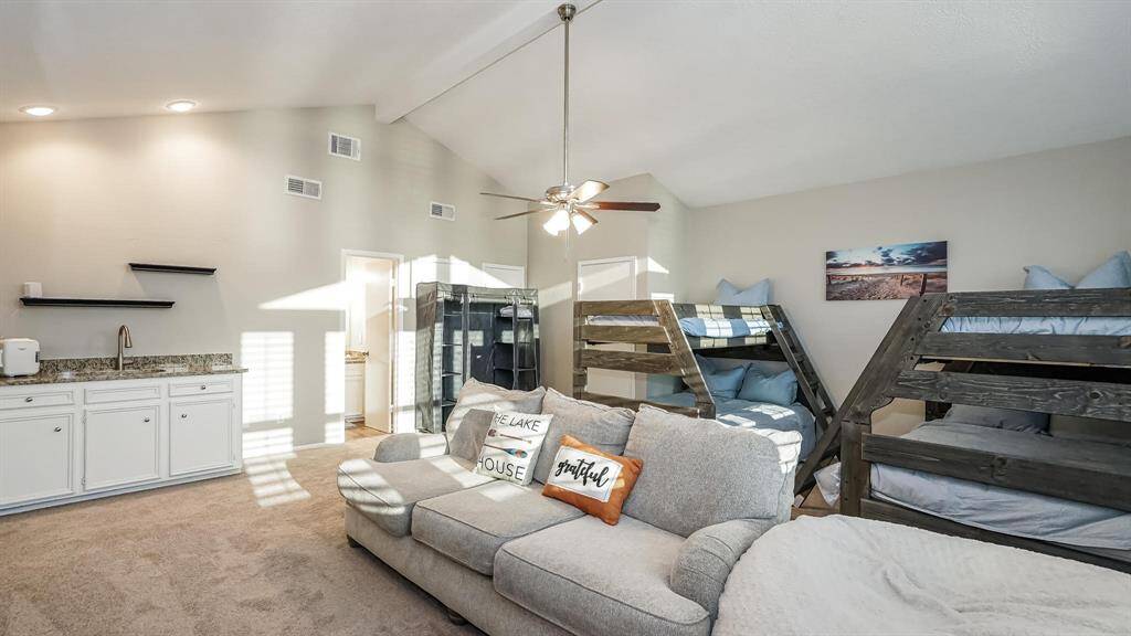 From this angle of the fourth bedroom you can see there is a wet bar with a utility sink.