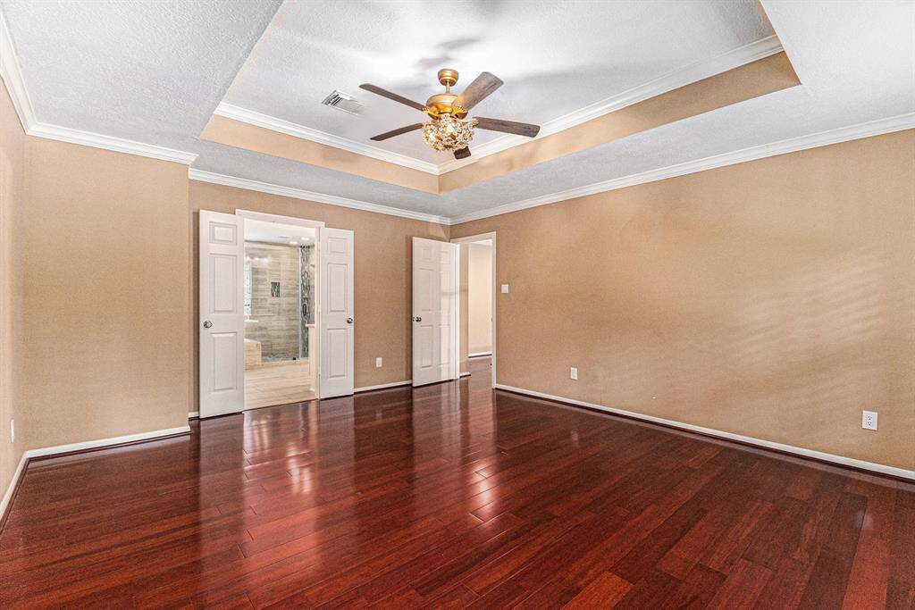 The luxurious Master Bath features tile walls that surround a large soaking tub and a huge walk-in shower with glass door. The window offers plenty of natural lighting.
