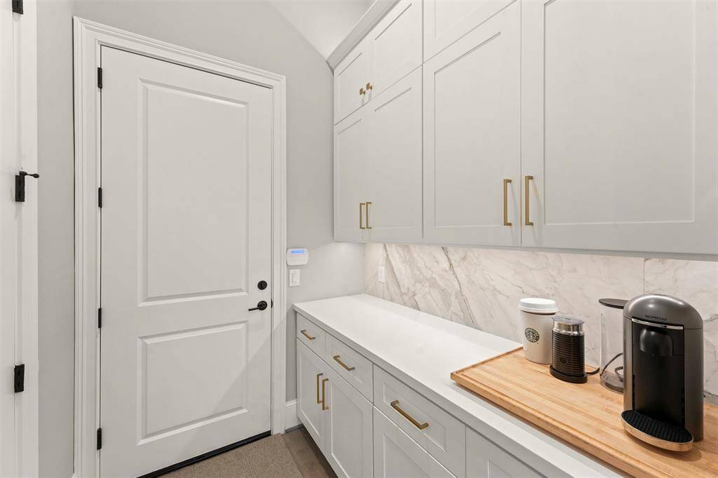Hold the phone, is that more cabinetry and counterspace? The butler's pantry is across from the huge pantry. Through that door is the 2 car garage.