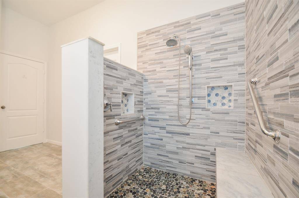The primary spacious, spa-like walk-in tile surround shower will surely be a sought after retreat after a day on the green!