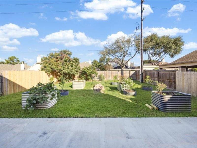 Backyard space with concrete patio.