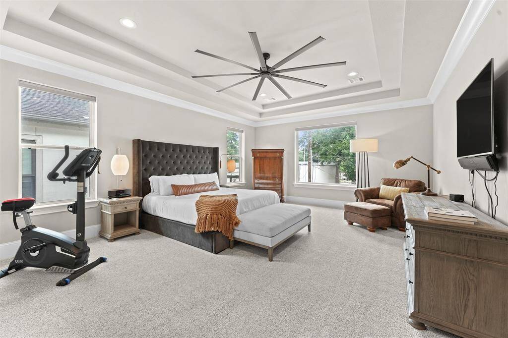 The primary bedroom is oversized and as luxurious as you'd expect. Brand new, plush carpet; blackout motorized Hunter Douglas shades; and oversized ceiling fan provide comfort to the discerning homeowner.