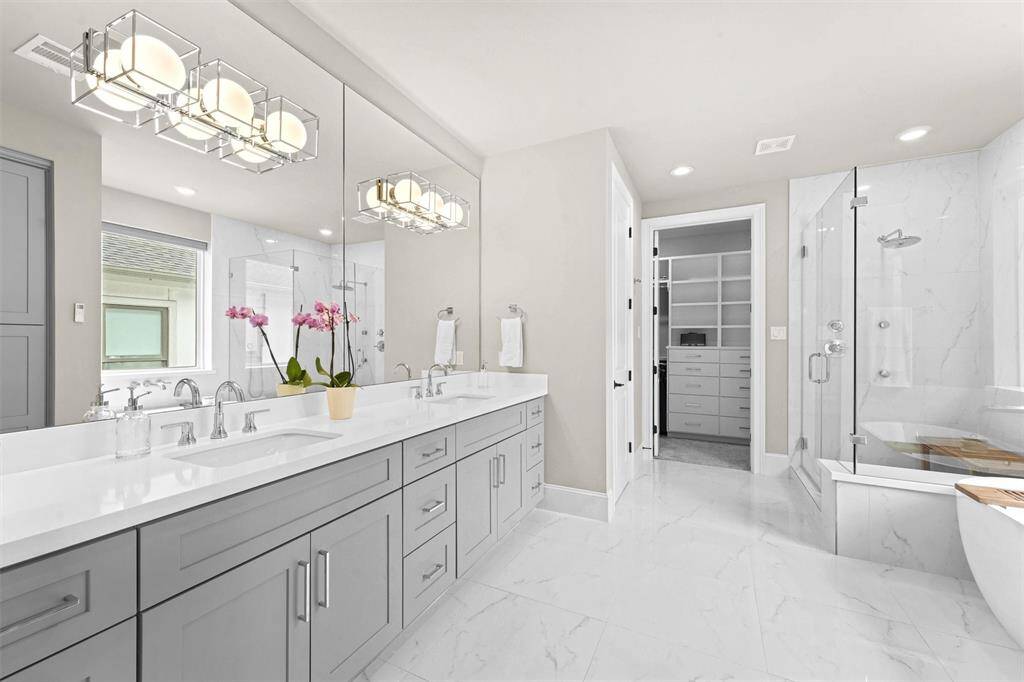 In a soothing color palate, the primary bathroom is the perfect place to start and end the day. Double sinks, quartz countertop and chrome hardware. Not shown is the water closet and linen closet.