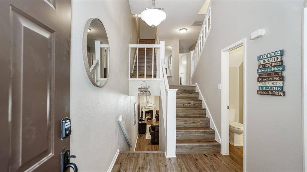 As soon as you enter this 4 story home you are greeted by laminate wood floors that flow throughout the living spaces.