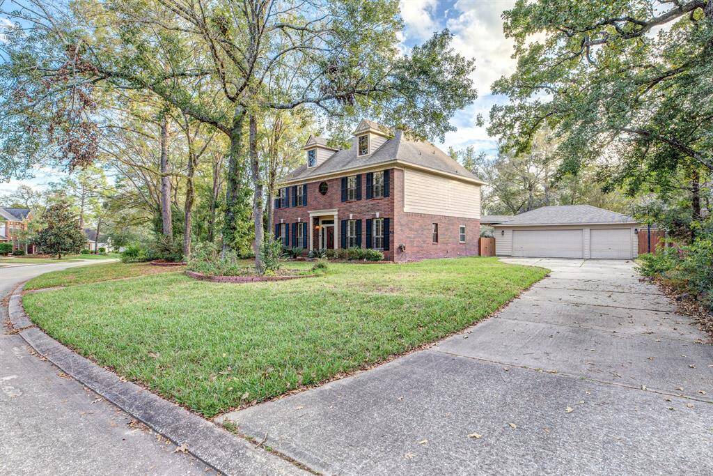 Boasting exceptional curb appeal, this home is surrounded by lush landscaping, vibrant flower beds, and mature trees, all maintained by a full sprinkler system—creating a picturesque and inviting first impression.
