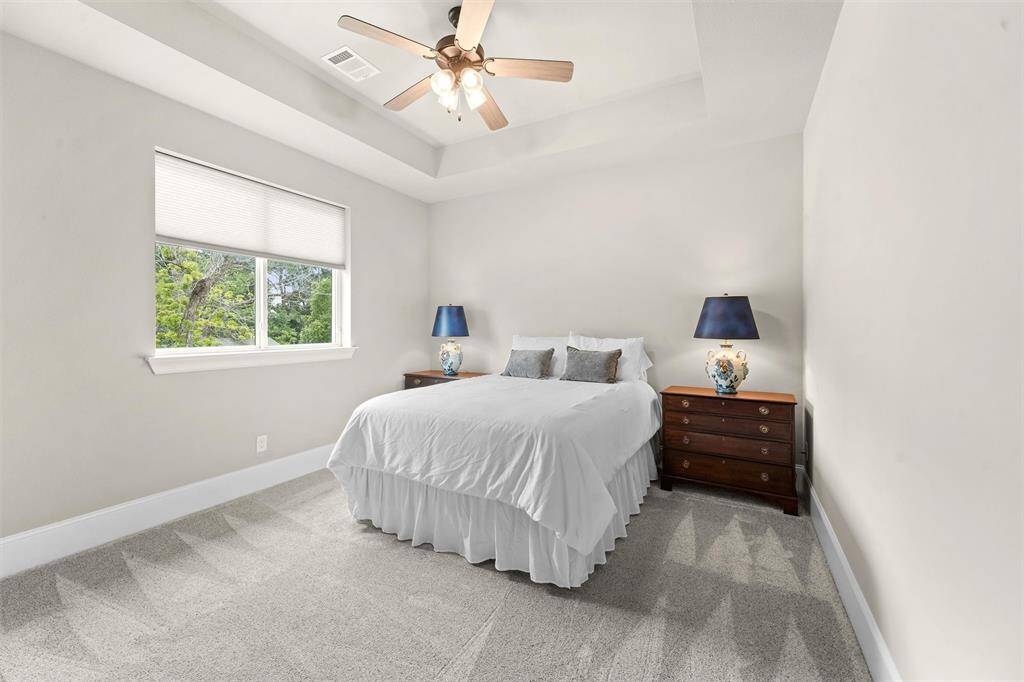 Secondary Bedroom #1, located at the front of the house. Featuring a generous walk-in closet and adjacent to Secondary Bathroom #1.