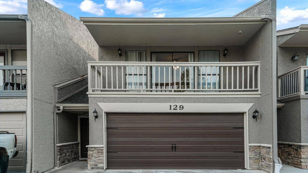 There is a two car garage with an auto garage door remote.