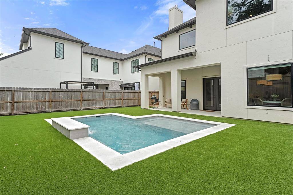 Finally, the cherry on top: the backyard! Featuring this brand-new, heated pool and turfed yard!