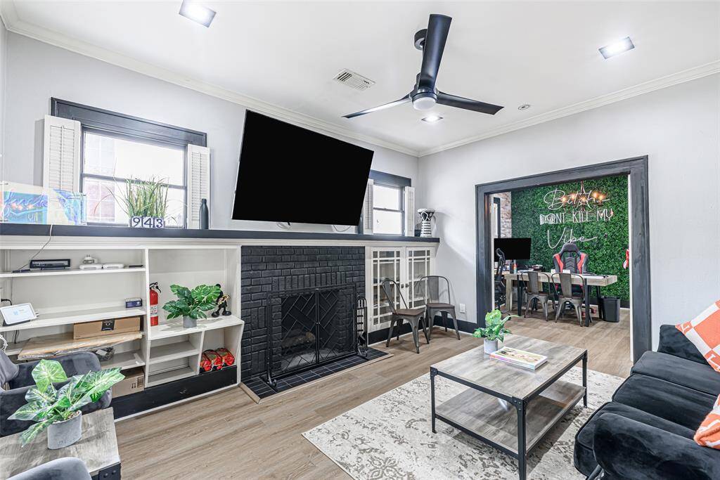 The inviting living room features updated flooring and ample natural light, creating a warm and welcoming atmosphere.