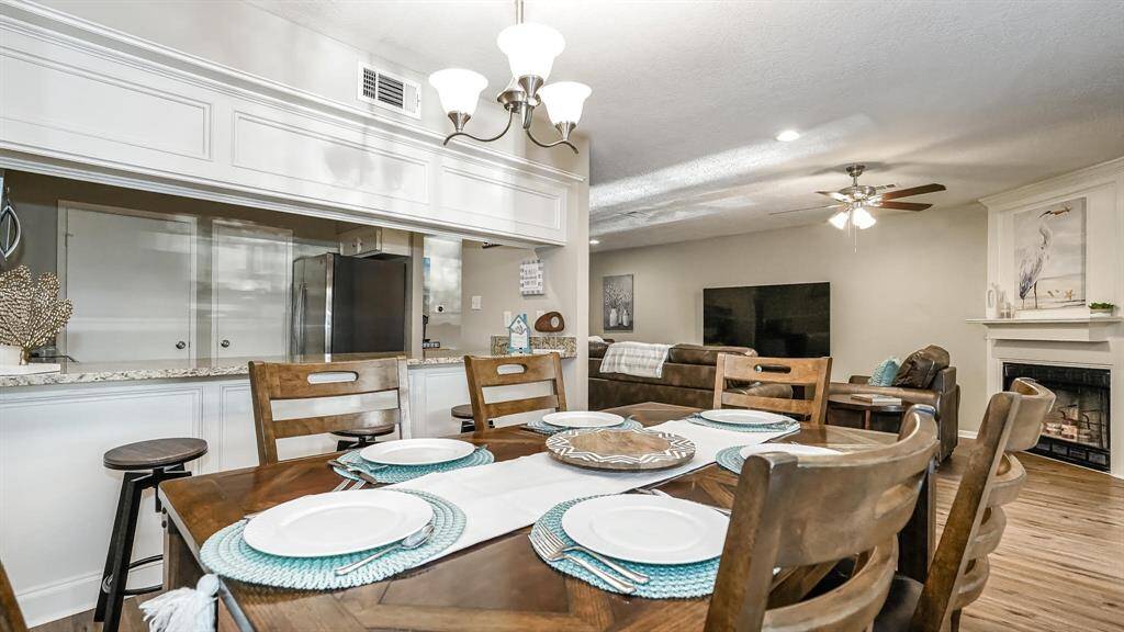The dining area has laminate wood floors.