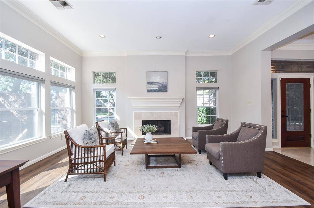 Grand Living Room features high ceilings, gas log fire place and abundance of natural light
