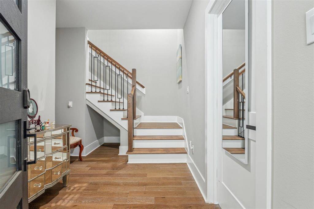 Welcoming first-floor foyer with access from both the garage and front door. The staircase invites you to the next level, with space for your favorite entry table or a personalized touch.