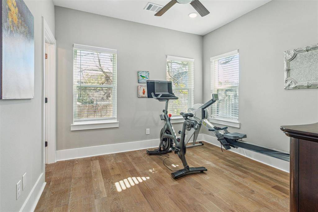 First-floor bedroom with en suite bathroom, walk-in closet, and plenty of windows that fill the space with natural light.