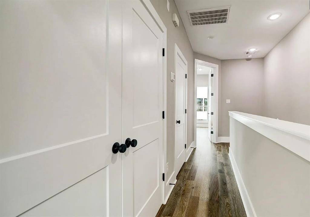 Upstairs hallway with convenient access to the laundry and more storage space.