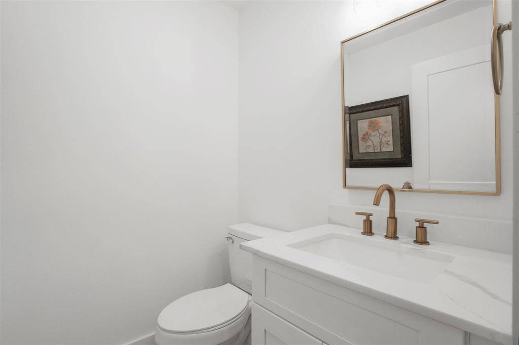 Convenient half bathroom for guests, located just off the second-floor living area.