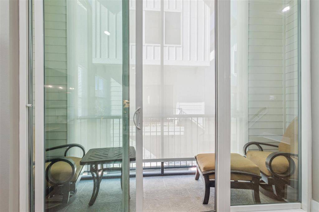 Motorized solar shade on the balcony for privacy and saves on energy costs.