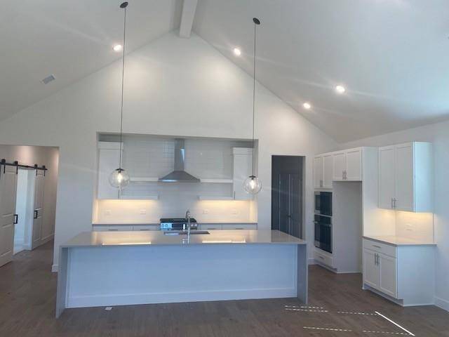Stylish island kitchen with quartz countertops and white cabinets